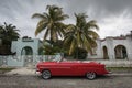 Old car on streets of Havana with beatiful palm trees in background. Cuba Royalty Free Stock Photo