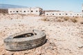 Old car tire dumped in desert landscape Royalty Free Stock Photo