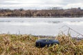 Old car tire on the river bank, environmental pollution Royalty Free Stock Photo