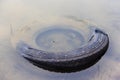 Old car tire submerged in water Royalty Free Stock Photo