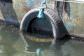 Old car tire used as a pontoon for boats