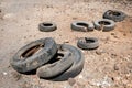 Old car tires dumped in desert landscape Royalty Free Stock Photo