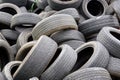 An old car tires stacked in a pile in area a car workshop, disposal recycling concepts