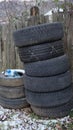 old car tires stand near an old wooden fence Royalty Free Stock Photo