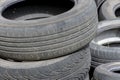 Old car tires, worn tread, worn rubber, a pile of old car wheels, a dump of worn tires from used cars. Environmental pollution Royalty Free Stock Photo