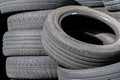 Old car tires, worn tread, worn rubber, a pile of old car wheels, a dump of worn tires from used cars. Environmental pollution Royalty Free Stock Photo