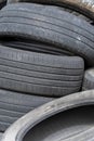 Old car tires, worn tread, worn rubber, a pile of old car wheels, a dump of worn tires from used cars. Environmental pollution Royalty Free Stock Photo