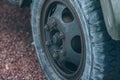 Old car wheel. Vintage car tires for offroad. Wheel of an old truck close-up.