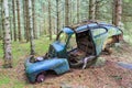 Old car wreck in the forest Royalty Free Stock Photo