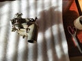 Old carburetor for a car engine with tools on table