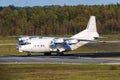 Old cargo airplane taking off with turboprop engine smoke emission