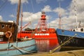 Old cargo boats moored at the quay of the former shipyard `Willemsoord` in the harbor of Den Helder, the Ne Royalty Free Stock Photo