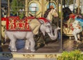 Old carousel colorful elephant in golden evening light Royalty Free Stock Photo