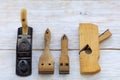 Old carpentry tools lie on a white wooden table Royalty Free Stock Photo