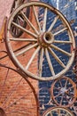 Old carriage wheels in collage against brick building Royalty Free Stock Photo