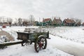 An old cart, with milk cans, covered in snow Royalty Free Stock Photo