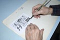 The old cartoonist hands drawing