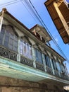 Old carved beautiful antique balcony of a wooden european house. European old architecture. Vertical photo