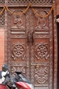 Old carved brown wooden door in Kathmandu