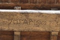 Old carved lettering on a wooden board on the Arnolfo Tower rooftop of Palazzo Vecchio, Florence, Tuscany, Italy. Royalty Free Stock Photo