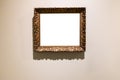Old carved wide bronze picture frame on brown wall