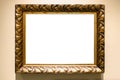 Old carved wide bronze picture frame on brown wall