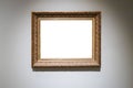 Old carved wide wooden picture frame on gray wall Royalty Free Stock Photo