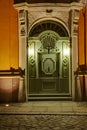 Old carved wooden door illuminated at night Royalty Free Stock Photo