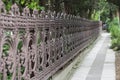 Old cast iron spiked fence in a city park Royalty Free Stock Photo