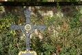 Old cast iron grave cross with gilded details