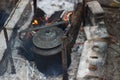 An old cast-iron kettle in a campfire Royalty Free Stock Photo