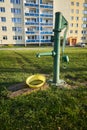 An old, cast-iron pump in front of a modern apartment block Royalty Free Stock Photo