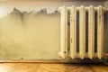 Old cast iron radiator hanging on the wall Royalty Free Stock Photo