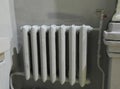 Old cast iron radiators near the wall Royalty Free Stock Photo
