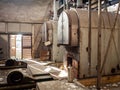 Old cast iron and steel industrial vintage oil and coal heating boilers in abandoned dark and gloomy boiler room dirty pipes Royalty Free Stock Photo