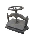 Old cast iron wheel turned book press isolated.