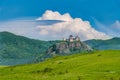 Old castle ruins and mountain background under blue sky and clouds. Hungary, Fuzer Castle. European Heritage site Royalty Free Stock Photo