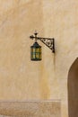 Old castle sand wall with lantern. Breath of antiquity Royalty Free Stock Photo