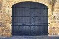 Old castle stone wall with big wooden doors. Retro wooden doors castle rock, great design for any purposes