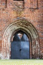 Old castle stone wall with closed big metal doors. Vintage gates. Retro doors, rock castle.