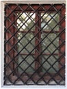 Old castle wooden window with iron lattice