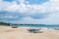 Old catamaran boats on the beach against the ocean and blue sky with beautiful clouds on a sunny day, Sri Lanka Royalty Free Stock Photo