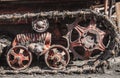 Rusty and dirty tracks and gearwheels of an old Tractor on the Scrapyard