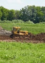 Old caterpillar tractor works in fields