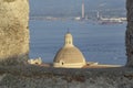 Old cathedral of Milazzo duome viewed through a bastione ancient wall with mediterranean sea and port