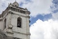 Old catholic church. White stone bell tower on blue sky background. Basilica de Santo Nino in Cebu Royalty Free Stock Photo