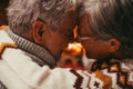 Old caucasian couple spending leisure time together at home. Loving husband and wife touching forehead looking at each other face Royalty Free Stock Photo