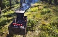 In the old cauldron on the barbecue cooking porridge against a forest clearing at noon Royalty Free Stock Photo