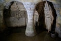 Old cave with desolated structure and stone pillar