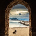 Old Cefalu beach through the archway